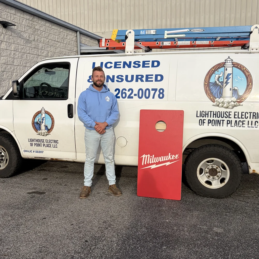 Casey Grup, owner of Lighthouse Electric of Point Place, with the company service van